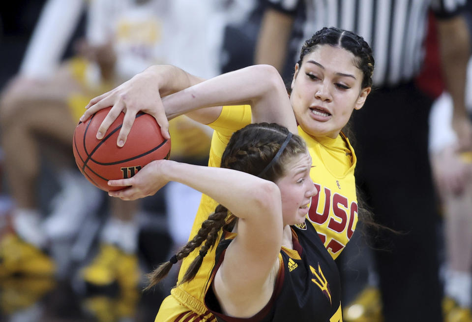 Southern California forward Alissa Pili (35) steals the ball from Arizona State guard Maggie Besselink (13) during an NCAA college basketball game in the first round of the Pac-12 women's tournament Wednesday, March 3, 2021, in Las Vegas. (AP Photo/Isaac Brekken)