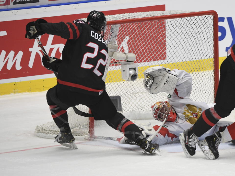 Canada's Dylan Cozens (22) scores past Russia goaltender Amir Miftakhov during second-period gold medal game action at the World Junior Hockey Championships, Sunday, Jan. 5, 2020, in Ostrava, Czech Republic. (Ryan Remiorz/The Canadian Press via AP)