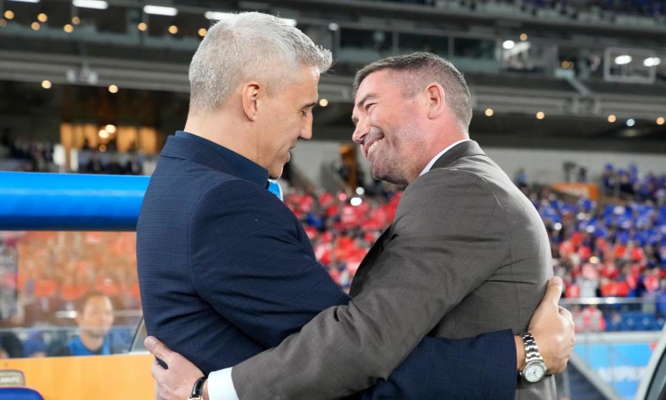 <span>Hernán Crespo and Harry Kewell embrace before the first leg of this year’s AFC Champions League final.</span><span>Photograph: Eugene Hoshiko/AP</span>