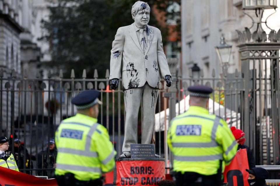 Climate protesters erected a Boris Johnson statue splattered in oil in Whitehall on Monday (AFP/Getty)