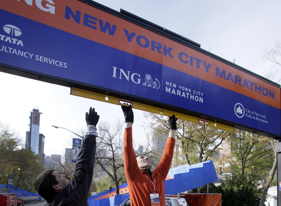 Workers assemble the finish line for the New York City Marathon in New York's Central Park, Thursday, Nov. 1, 2012. The crane atop a high rise that collapsed during superstorm Sandy is visible at background left. (AP Photo/Richard Drew)Workers assemble the finish line for the New York City Marathon in New York's Central Park, Thursday, Nov. 1, 2012. The New York City Marathon is on Sunday, with many logistical questions to be answered. (AP Photo/Richard Drew)