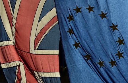 A British Union flag and a European Union flag hang from a building in central London, Britain February 18, 2016. REUTERS/Toby Melville