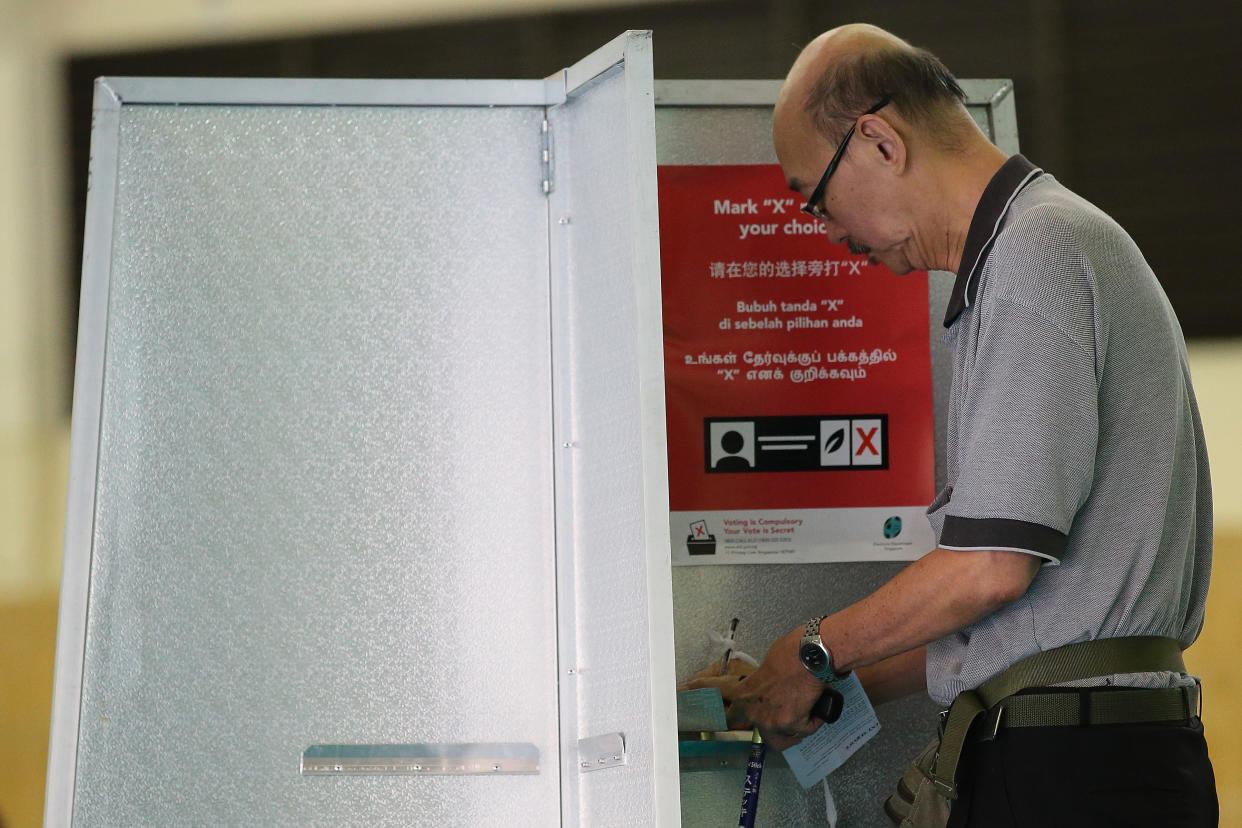 SINGAPORE - SEPTEMBER 11:  A resident casts his vote at a polling station on  September 11, 2015 in Singapore. About 2.5 million voters are expected to visit polling station islandwide. The 2015 general election sees all 89 parliamentary seats being contested for the first time since independence in 1965. This is also the first election in Singapore's history without founding Prime Minister, Lee Kuan Yew, who passed away in March this year.  (Photo by Suhaimi Abdullah/Getty Images)