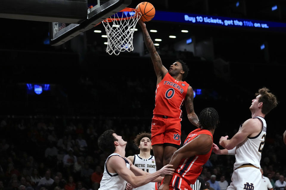 Auburn's K.D. Johnson (0) shoots over Notre Dame's Logan Imes, Braeden Shrewsberry (11) and Matt Zona (25) during the second half of an NCAA college basketball game in the Legends Classic tournament Thursday, Nov. 16, 2023, in New York. (AP Photo/Frank Franklin II)