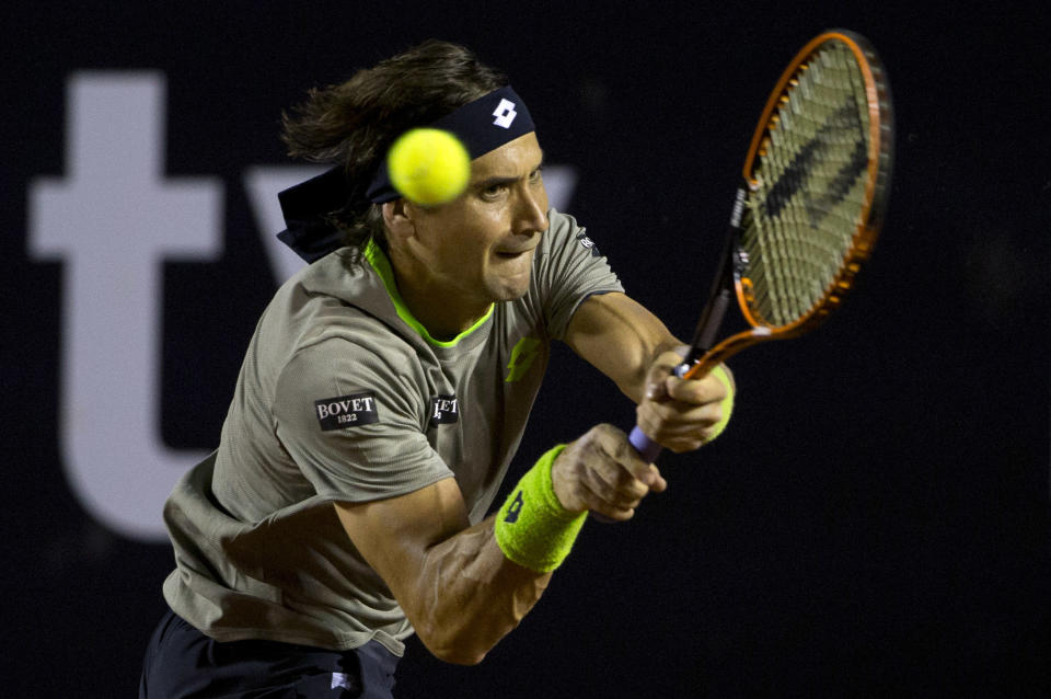 David Ferrer of Spain returns the ball to Jeremy Chardy of France at the Rio Open tennis tournament in Rio de Janeiro, Brazil, Tuesday, Feb. 18, 2014. (AP Photo/Silvia Izquierdo)