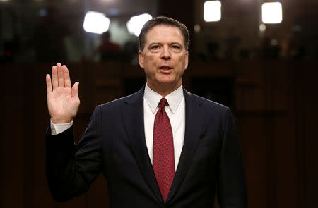 FILE PHOTO: Former FBI Director James Comey is sworn in prior to testifying before a Senate Intelligence Committee hearing on Russia's alleged interference in the 2016 U.S. presidential election on Capitol Hill in Washington, U.S., June 8, 2017. REUTERS/Jonathan Ernst/Files