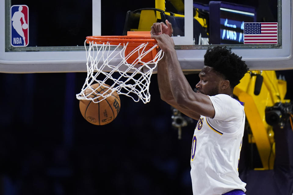 Los Angeles Lakers' Damian Jones dunks the ball during the first half of an NBA basketball game against the Washington Wizards, Sunday, Dec. 18, 2022, in Los Angeles. (AP Photo/Jae C. Hong)