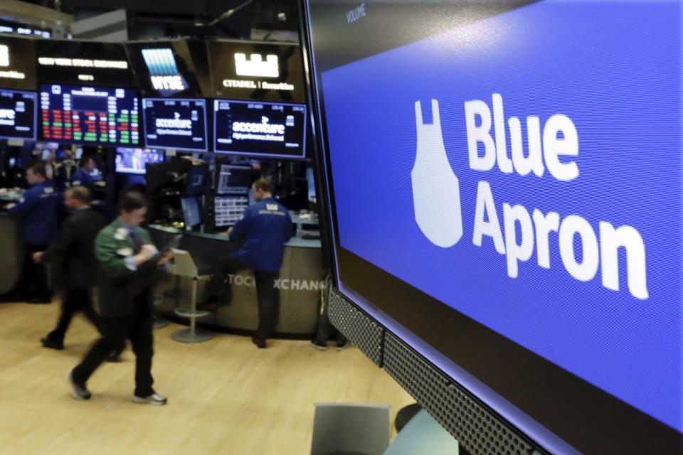 FILE - In this Thursday, Oct. 19, 2017, file photo, the logo for Blue Apron appears on a screen above the trading floor of the New York Stock Exchange. Meal kit companies face an ultimatum: Adapt or die. The struggle has intensified for Blue Apron, which announced that it could be delisted from the New York Stock Exchange because its closing share price has been lower than $1 since early May 2019. (AP Photo/Richard Drew, File)