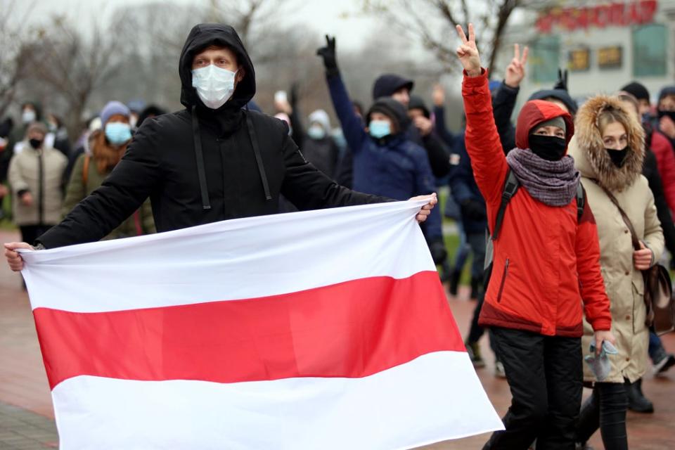 File photo: Opposition supporters parade through the streets during a rally to protest against police violence and Belarus presidential election results in Minsk, 22 November 2020 (AFP via Getty Images)