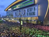 Thousands of fans gather outside Fiserv Forum to watch on a video screen as the Milwaukee Bucks play at Phoenix in Game 1 of the NBA Finals on Monday, July 5, 2021, in Milwaukee. Bucks officials said 9,000 fans watched the game on a video screen inside Fiserv Forum and another 20,000 watched in the “Deer District” outside the arena. The Bucks are in the Finals for the first time since 1974 as they chase their first championship since 1971. (AP Photo/Steve Megargee)