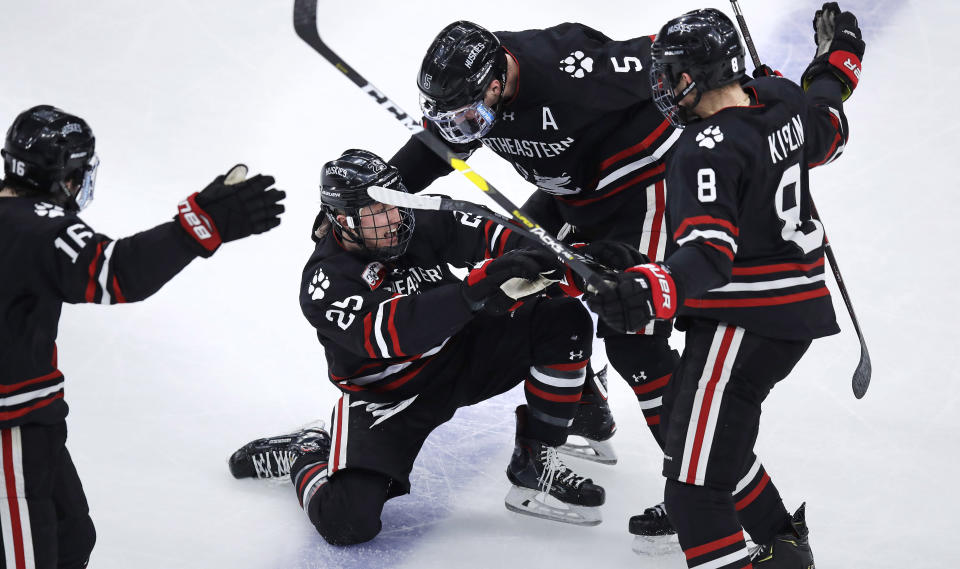 Northeastern forward Patrick Schule (25) is congratulated by teammates after his goal during the second period of the NCAA hockey Beanpot tournament championship game against Boston College in Boston, Monday, Feb. 11, 2019. (AP Photo/Charles Krupa)