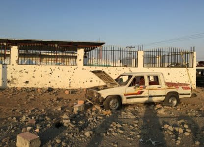 A car sits next to a salvage yard hit by a Houthi rocket in an industrial area in eastern Najran city, Saudi Arabia August 27, 2016. REUTERS/Katie Paul