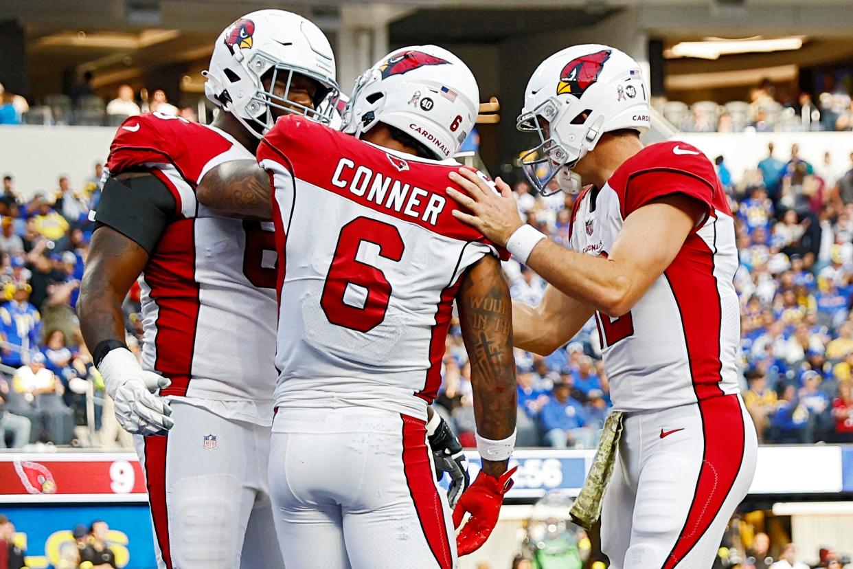 James Conner #6  celebrates with Colt McCoy #12 and Kelvin Beachum #68 of the Arizona Cardinals after a touchdown in the second quarter of the game against the Los Angeles Rams at SoFi Stadium on November 13, 2022, in Inglewood, California.