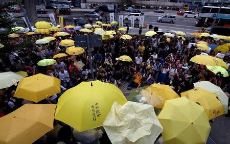 FILE PHOTO: Pro-democracy protesters carrying yellow umbrellas, symbol of the Occupy Central civil disobedience movement, stage a three-minute silence outside government headquarters in Hong Kong to mark the second anniversary of the movement, China September 28, 2016. REUTERS/Bobby Yip