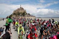 Cycling - The Tour de France cycling race - The 188-km (117 miles) 1st stage from Mont Saint-Michel to Utah Beach Sainte-Marie-du-Mont - 02/07/2016 - The pack of riders take the start from the Mont Saint-Michel. REUTERS/Juan Medina