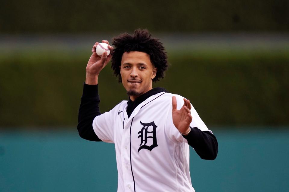 Detroit Pistons' Cade Cunningham, the first overall selection in the NBA basketball draft throws out the ceremonial first pitch at the baseball game between the Detroit Tigers and the Baltimore Orioles, Friday, July 30, 2021 in Detroit. (AP Photo/Carlos Osorio)