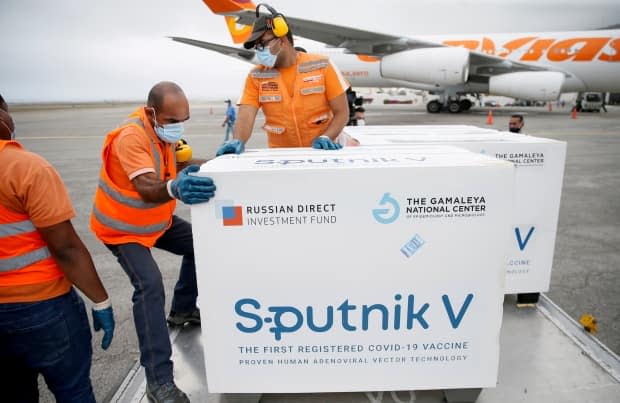 Workers unload a shipment of Russia's Sputnik V COVID-19 vaccine at the airport in Caracas, Venezuela, back on March 29. 