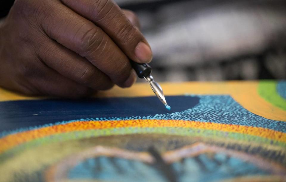 “Pointillism — it appears to me to be psychedelic,” artist Gary Harrell said while working on an abstract butterfly painting on wood Wednesday, May 10, 2023, while at home in south Sacramento. Harrell began creating art while incarcerated for over 40 years before being released in 2020 from San Quentin State Prison.