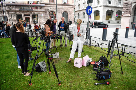 Journalists and press photographers wait outside Rosenbad, the Swedish government headquarters, where ministers meet after the opposition united to demand no-confidence votes against three cabinet ministers, in Stockholm, Sweden, July 26, 2017. TT News Agency/Erik Simander/via REUTERS