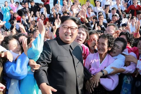 North Korean leader Kim Jong-un poses with citizens in Pyongyang - Credit: Reuters