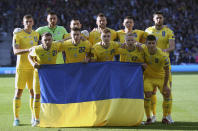 Ukrainian players pose ahead of the World Cup 2022 qualifying play-off soccer match between Scotland and Ukraine at Hampden Park stadium in Glasgow, Scotland, Wednesday, June 1, 2022. (AP Photo/Scott Heppell)