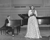 <p>1955 – MARIAN ANDERSON – ENTERTAINMENT – First African-American member of the Metropolitan Opera. — Singer Marian Anderson (1897-1993), accompanied at the piano, sings during a recital at Carnegie Hall in New York City, USA, circa 1965. Anderson is wearing a full-lenth lace gown. (Authenticated News/Archive Photos/Getty Images) </p>