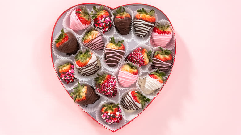 A heart-shaped box of chocolate-covered strawberries