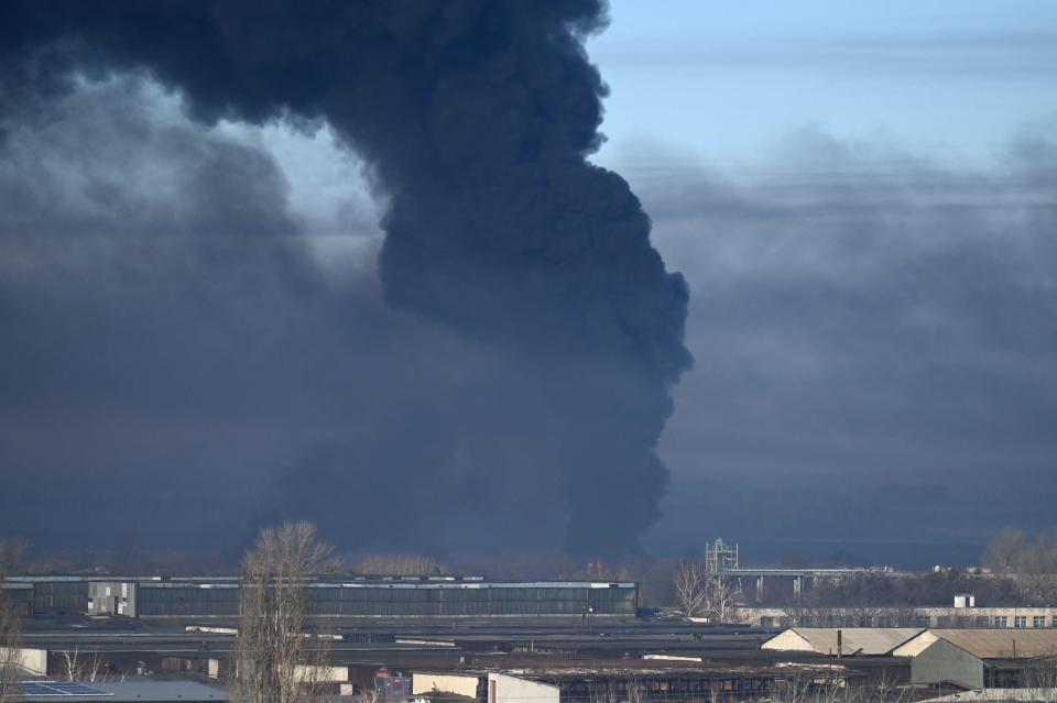 Black smoke rises from a military airport near Kharkiv, Ukraine, on Feb. 24.