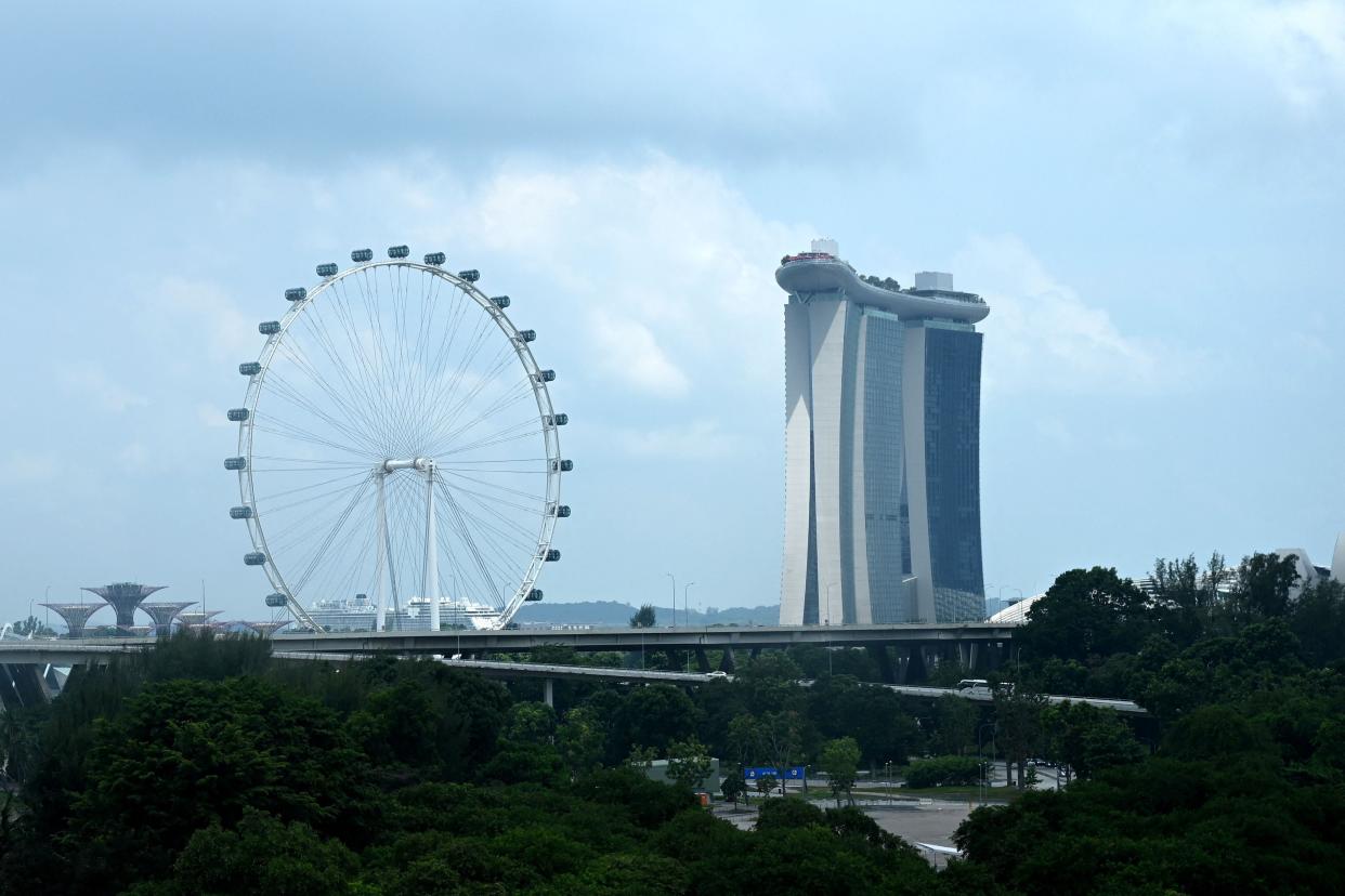 A representational image of Singapore.  A general view shows the Singapore Flyer observation wheel (L) and the Marina Bay Sands hotel (R) in Singapore on 16 July  2021 (AFP via Getty Images)