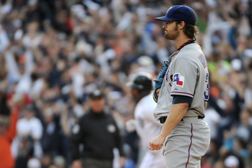 DETROIT, MI - OCTOBER 13: C.J. Wilson #36 of the Texas Rangers looks on as Delmon Young #21 of the Detroit Tigers runs the bases after hitting a solo home run in the fourth inning of Game Five of the American League Championship Series at Comerica Park on October 13, 2011 in Detroit, Michigan. (Photo by Harry How/Getty Images)