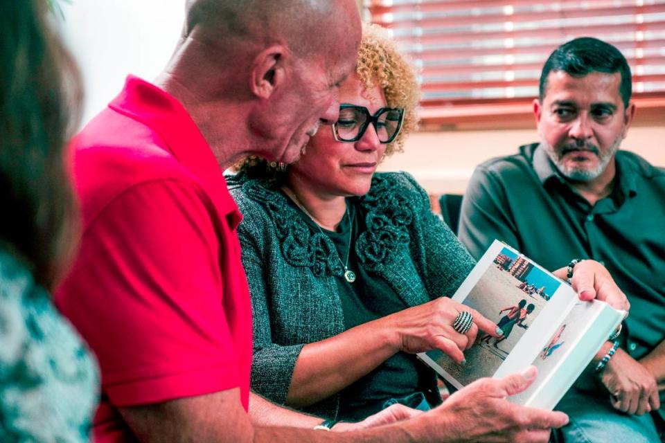 The parents of Derbin Huertas Jr., Ana and Derbin Sr., share family photos with cornea recipient Art Durshimer at Lions World Vision Institute in Ybor City. Ricky De Silva