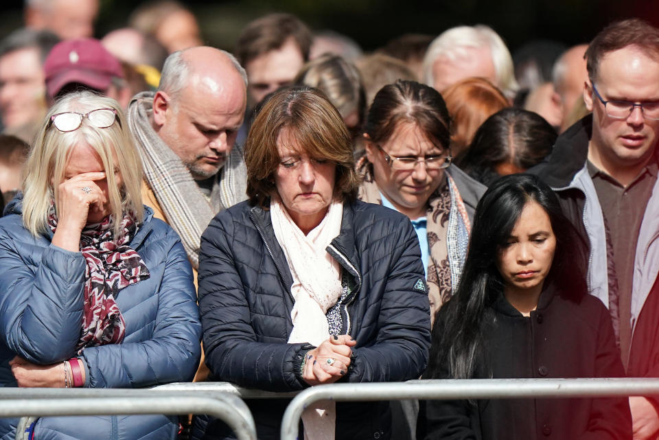 Members of the public on the Mall listen to the State Funeral of Queen Elizabeth II, held at Westminster Abbey, London. Picture date: Monday September 19, 2022.