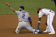 New York Mets' Dominic Smith (2) gestures toward the dugout as he kneels at second with a double next to Washington Nationals third baseman Josh Harrison (5) during the fifth inning of a baseball game, Thursday, Sept. 24, 2020, in Washington. (AP Photo/Nick Wass)