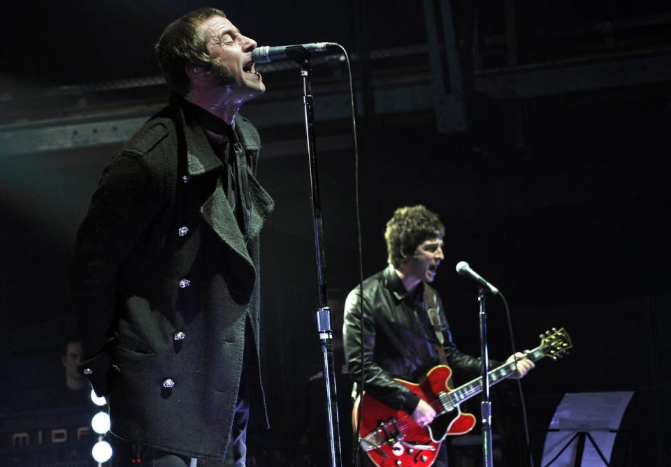 Liam and Noel Gallagher performing as part of Oasis in 2009 (DDP/AFP/Getty)