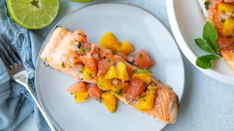 baked salmon with citrus salsa on white plate