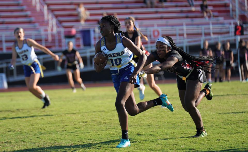 Martin County's Laniyah Smalls runs back an interception as Vero Beach's Ratajah Dawson makes the tackle during a high school flag football game on Wednesday, Apr. 6, 2023 in Vero Beach. Martin County won 6-0.