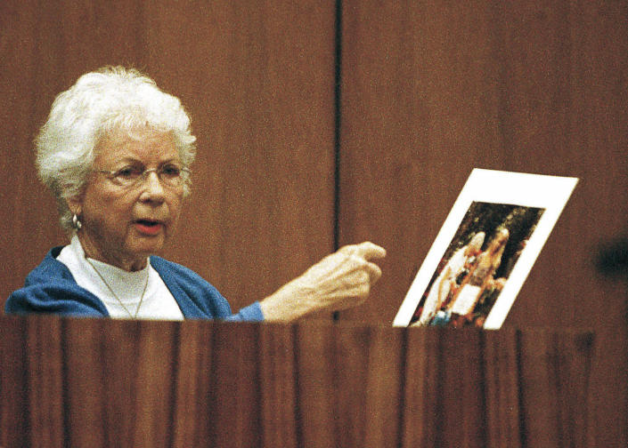 FILE - Louise Ireland gestures towards a color enlargement, the last taken of her daughter, Dana Ireland, before her death, while testifying in Hilo, Hawaii, on July 26, 1999. A petition outlining new evidence in one of Hawaii's biggest criminal cases asks a judge to release a Native Hawaiian man who has spent more than 20 years in prison for the sexual assault, kidnapping, and murder of Ireland on the Big Island. (W.M. Ing/Hawaii Tribune-Herald via AP, Pool, File)