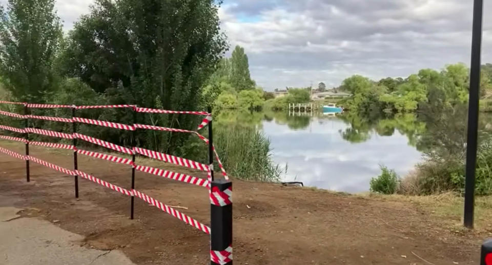 A photo of River Derwent, with police tape around poles that had to be taken down to retrieve Mr Nicholson's car and body.  