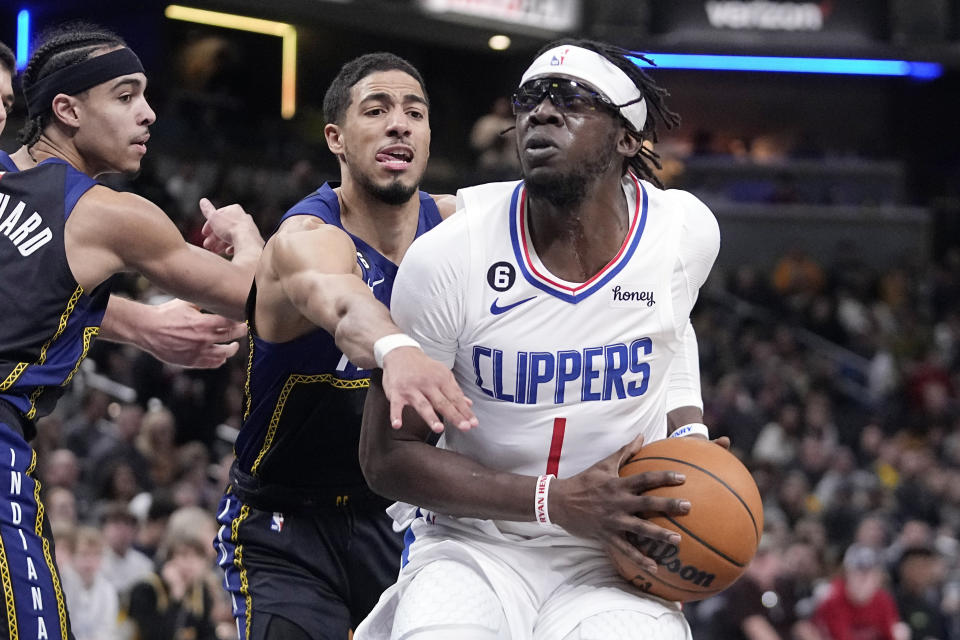 LA Clippers' Reggie Jackson (1) goes to the basket against Indiana Pacers' Tyrese Haliburton (0) during the second half of an NBA basketball game, Saturday, Dec. 31, 2022, in Indianapolis. (AP Photo/Darron Cummings)