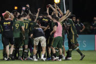 Portland Timbers players celebrate after defeating Orlando City 2-1, during an MLS soccer tournament, Tuesday, Aug. 11, 2020, in Kissimmee, Fla. (AP Photo/John Raoux)