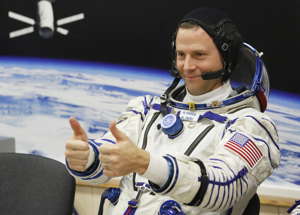 U.S. astronaut Nick Hague Russian, member of the main crew of the expedition to the International Space Station (ISS), gestures prior the launch of Soyuz MS-12 space ship at the Russian leased Baikonur cosmodrome, Kazakhstan, Thursday, March 14, 2019. (AP Photo/Dmitri Lovetsky)