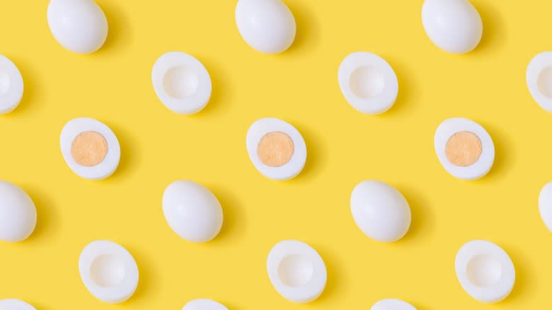sliced boiled eggs yellow background