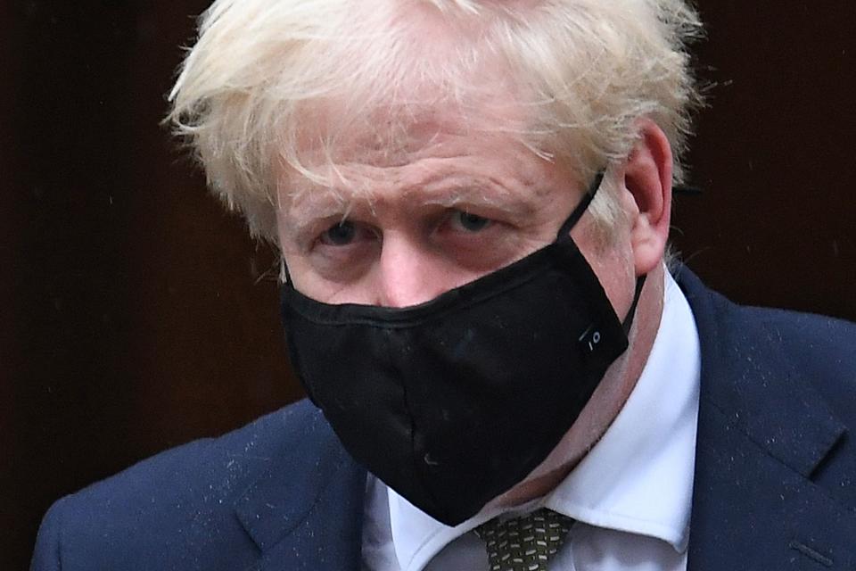 Britain's Prime Minister Boris Johnson wearing a face mask as a precaution against the transmission of the novel coronavirus leaves 10 Downing Street in central London on October 12, 2020 headed for the House of Commons, where he is set to announce a new COVID-19 alert system. - British Prime Minister Boris Johnson was set to present a new three-tiered alert system for coronavirus cases in England on Monday, with Liverpool in the northwest expected to be the only city placed in the top category. (Photo by Daniel LEAL-OLIVAS / AFP) (Photo by DANIEL LEAL-OLIVAS/AFP via Getty Images)