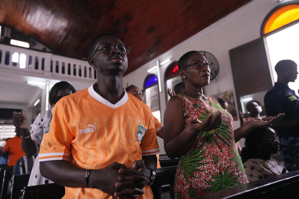Catholic faithful pray at the Chapelle de l'Externat Saint Paul Church in Abidjan, Ivory Coast, Wednesday, Feb. 7, 2024. Ivory Coast's seemingly miraculous progression to the Africa Cup of Nations semifinals has convinced locals that God is on their side. The host nation has survived several close shaves with elimination thanks to fortune with results in other games and scarcely believable comebacks. (AP Photo/Sunday Alamba)