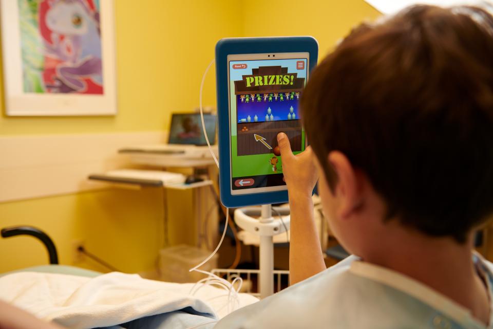Cincinnati Children's Hospital patient Ethan Stallsworth plays an EZ Induction game.