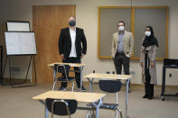 Garth Reeves, left, and Scott Canfield, center, co-founders of the Why Not You Academy charter school, pose for a photo with Halma Abubakar, right, founding director of operations, in a classroom at the under-construction facility, Tuesday, Oct. 27, 2020, in Des Moines, Wash., south of Seattle. Seattle Seahawks NFL football quarterback Russell Wilson and his Grammy-winning wife, pop singer Ciara, are putting their money and celebrity behind rebranding the charter school, which advocates hope will boost the troubled Washington state charter school sector that has suffered from enrollment problems after years of legal challenges. (AP Photo/Ted S. Warren)