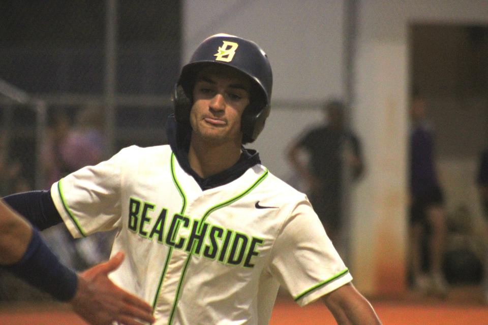 Beachside outfielder Derek Ochoa celebrates with teammates after scoring the second run in the Barracudas' 2-0 win over Columbia.