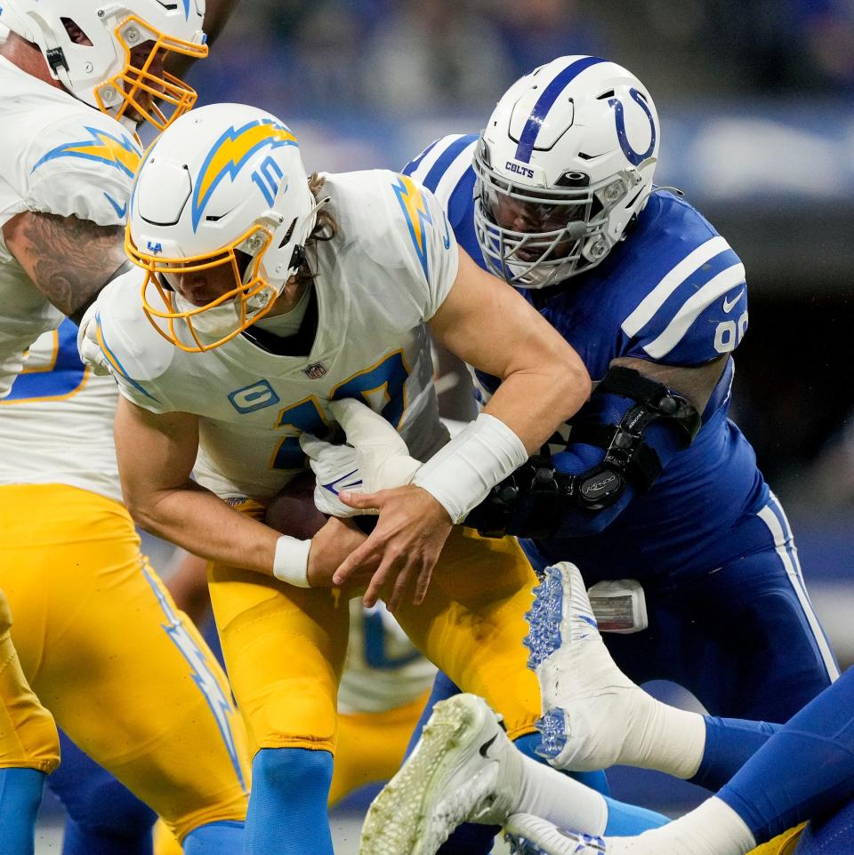 Indianapolis Colts defensive tackle DeForest Buckner (99) sacks Los Angeles Chargers quarterback Justin Herbert (10) on Monday, Dec. 26, 2022, during a game against the Los Angeles Chargers at Lucas Oil Stadium in Indianapolis.