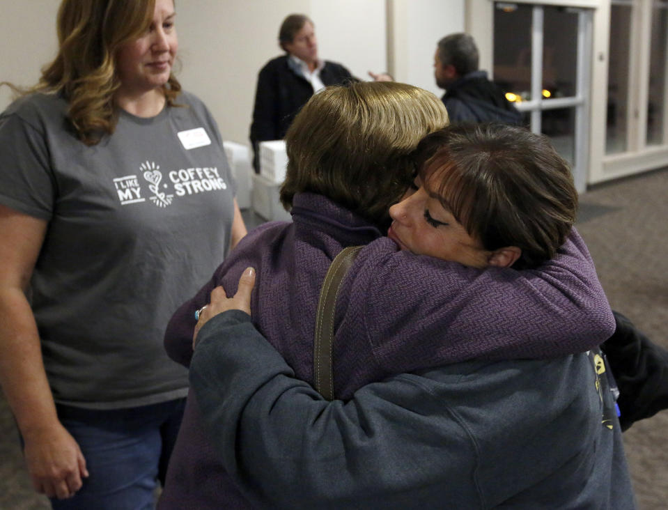 In this photo taken Tuesday, Dec. 11, 2018, Camp Fire survivor Terese Mangino, right, embraces Tubbs Fire survivor Anne Barbour as fellow survivor Tricia Woods, left, looks on, after a meeting with Camp Fire survivors in Chico, Calif. Survivors of a deadly wildfire that last year tore through California's wine country are sharing lessons of loss and pain but also of resilience with those who last month escaped the deadliest U.S. wildfire in at least a century. The Press Democrat reports a group of Sonoma County residents spent Tuesday in a packed meeting with residents of Paradise and several nearby communities who grilled them with questions. (Alvin Jornada/The Press Democrat via AP)