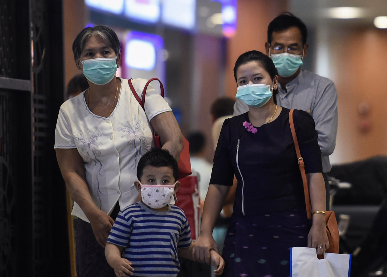 People wear protective facemasks at the Yangon international aiport in Yangon on January 31, 2020. - Myanmar airlines suspend their China flights while the World Health Organization declared a global emergency over the new coronavirus, as China reported on January 31 the death toll had climbed to 213 with nearly 10,000 infections. (Photo by Ye Aung THU / AFP) (Photo by YE AUNG THU/AFP via Getty Images)